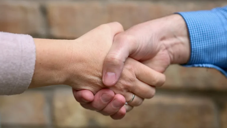 Close-up of two people shaking hands